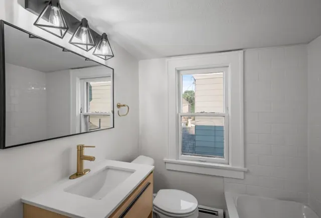 Bathroom with subway tile, wood vanity and gold-finish faucet, St. Paul, MN