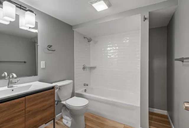 Bathroom with subway tile tub surround and walnut vanity, Twin Cities
