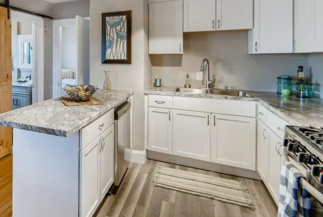 White shaker kitchen with peninsula and new flooring, St. Paul, MN